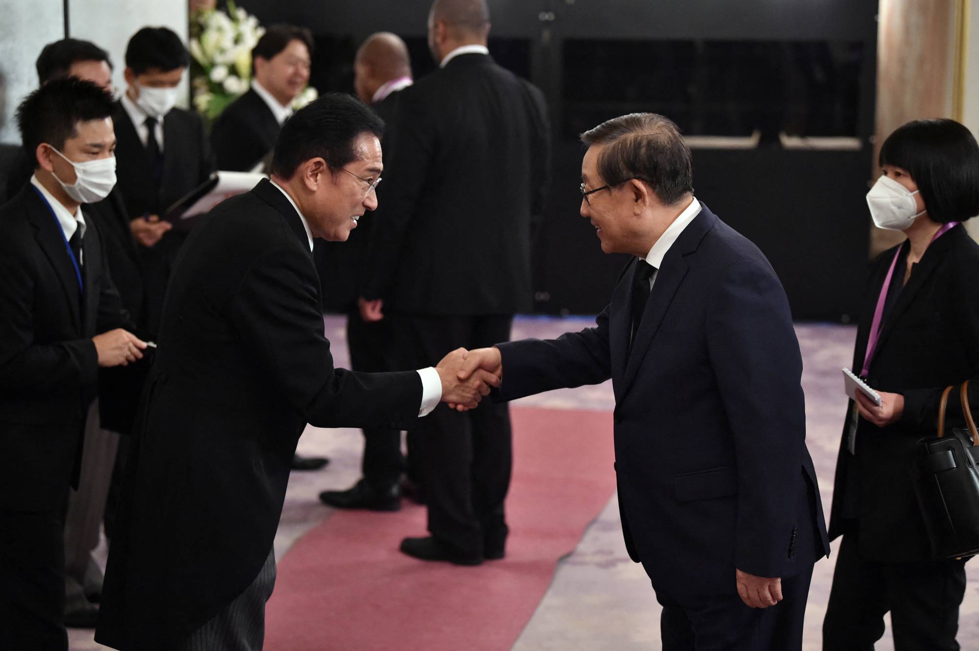 Prime Minister Fumio Kishida welcomes China's former science and technology minister, Wan Gang, before a reception at the Akasaka State Guest House in Tokyo following the state funeral for former Prime Minister Shinzo Abe. | POOL / VIA REUTERS
