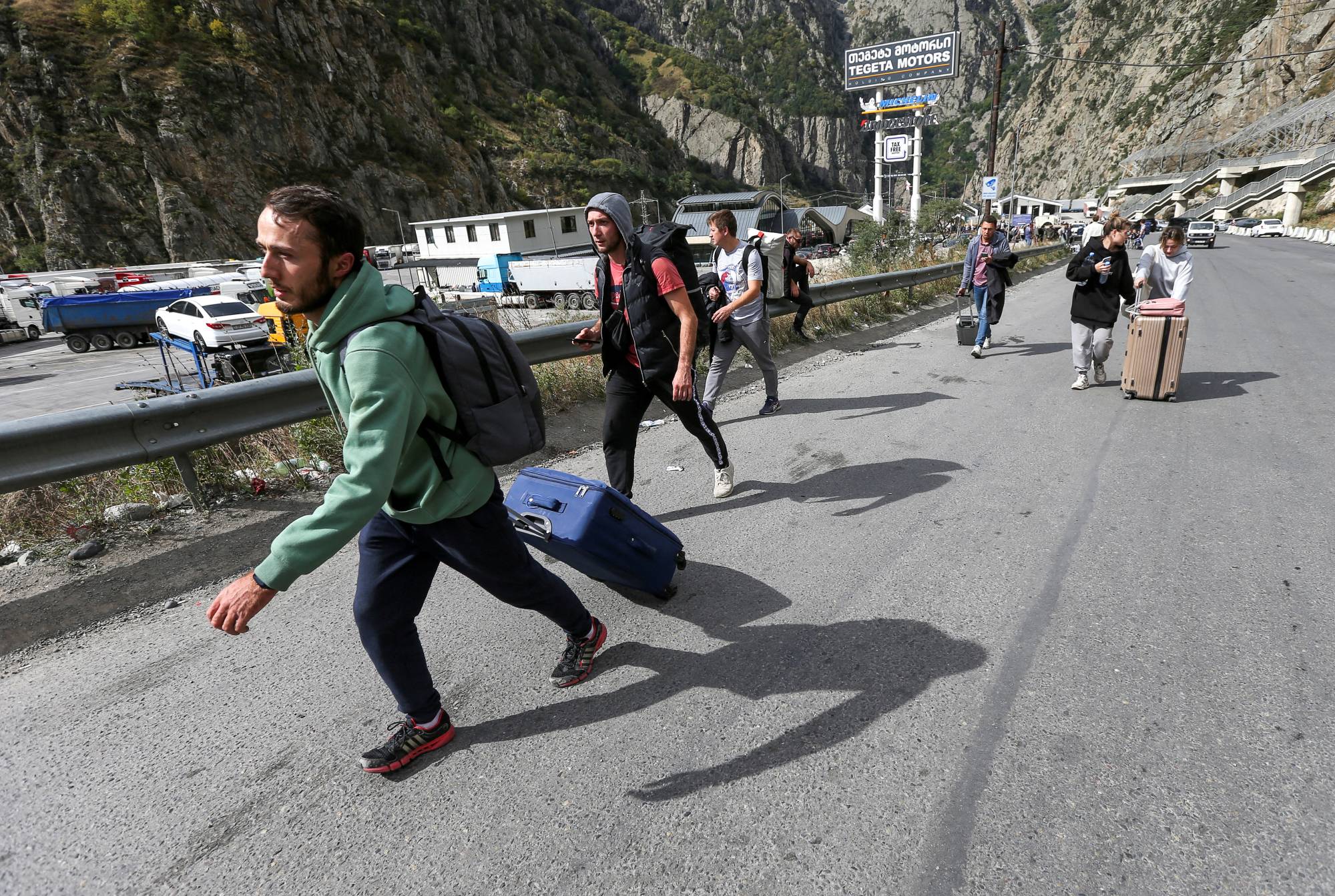 Travelers after crossing the border with Russia at the Verkhny Lars frontier checkpoint in Zemo Larsi, Georgia, on Wednesday | REUTERS