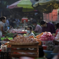 People shop at a market after army seized power in a coup in Yangon, Myanmar, in February 2021. | REUTERS