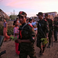 Anti-coup fighters are given flowers by local residents in a township in Myanmar\'s northwestern Sagaing region on Aug. 16. | AFP-JIJI