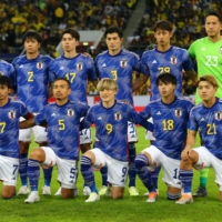 Japan\'s players pose for a group photo before their match against Ecuador in Dusseldorf, Germany, on Tuesday.  | REUTERS