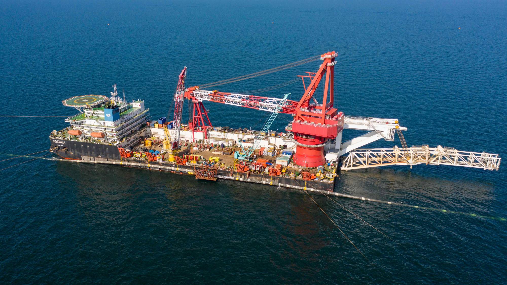 Specialists on the laybarge ship Fortuna performing an above water tie-in during the final stage of Nord Stream 2 pipeline construction in the Baltic Sea in September 2021. Two leaks have been identified on the Nord Stream 1 Russia-to-Europe gas pipeline in the Baltic Sea, hours after a similar incident on its twin pipeline Nord Stream 2, Scandinavian authorities said on Tuesday. | NORD STREAM 2 AG / VIA AFP-JIJI