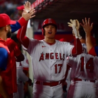 Shohei Ohtani returns to the dugout after scoring against the A\'s in Anaheim, California, on Wednesday. | USA TODAY / VIA REUTERS