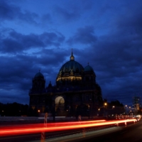 The Television Tower glows at dusk next to the Protestant Berlin Cathedral, with reduced lighting, to save energy due to Russia\'s invasion of Ukraine, in Berlin in August. | REUTERS
