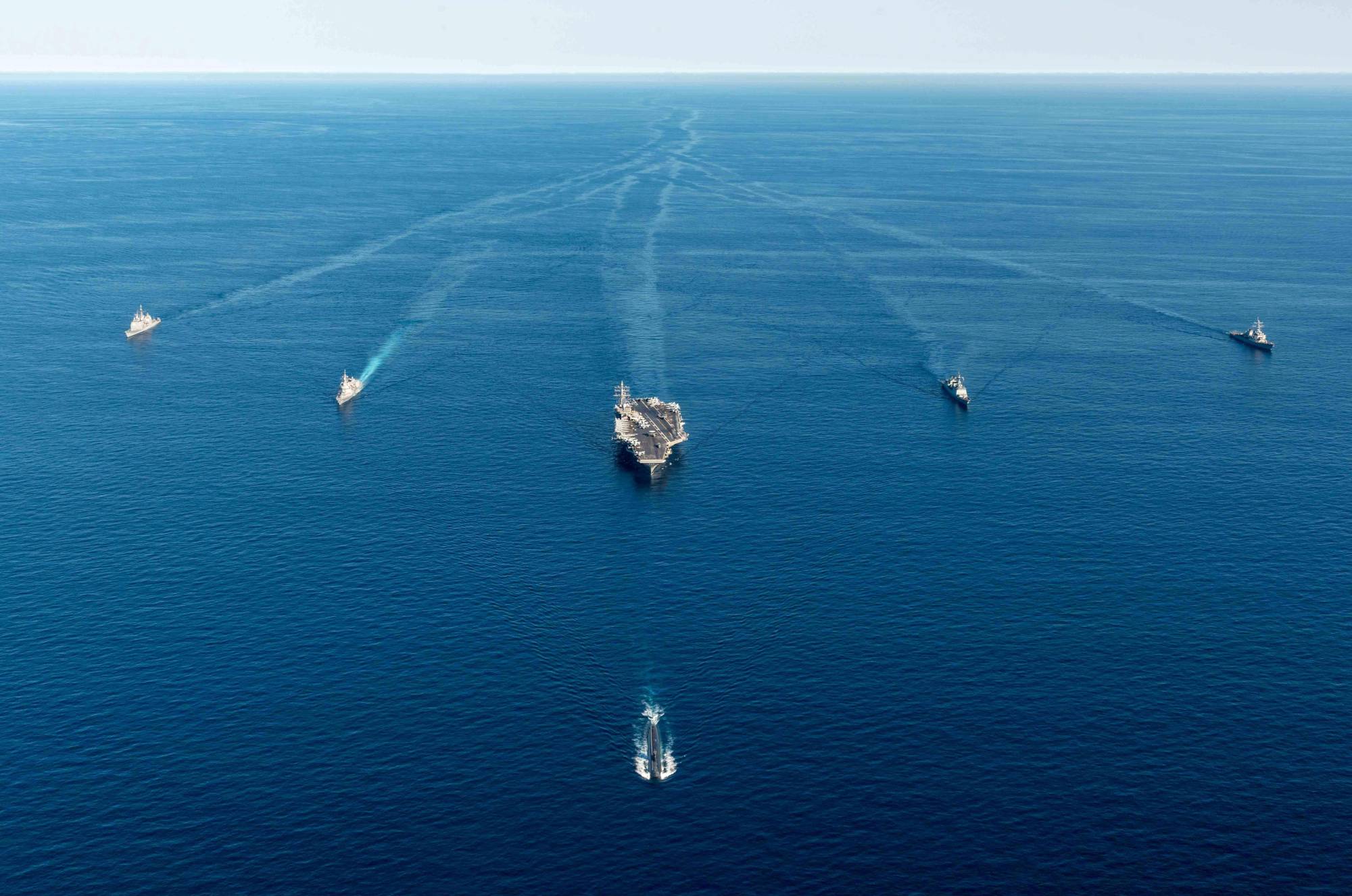 Warships including the U.S. Navy's nuclear-powered USS Annapolis submarine (bottom), the nuclear-powered USS Ronald Reagan aircraft carrier (center), South Korea's Munmu the Great destroyer (second from right) and Japan's Asahi-class destroyer (second from left) during a trilateral anti-submarine exercise in international waters off the Korean Peninsula on Friday | SOUTH KOREAN DEFENSE MINISTRY / VIA AFP-JIJI