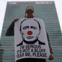 A protester demonstrates against Russian President Vladimir Putin outside the United Nations after U.N. Security Council members voted on a resolution condemning the referendums on annexing several Russia-occupied regions of Ukraine, in Manhattan, New York, on Friday. | REUTERS