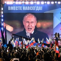 Russian President Vladimir Putin is seen on a screen in Moscow\'s Red Square as he addresses a rally and a concert marking the annexation of four Russian-occupied regions of Ukraine on Friday. | AFP-JIJI