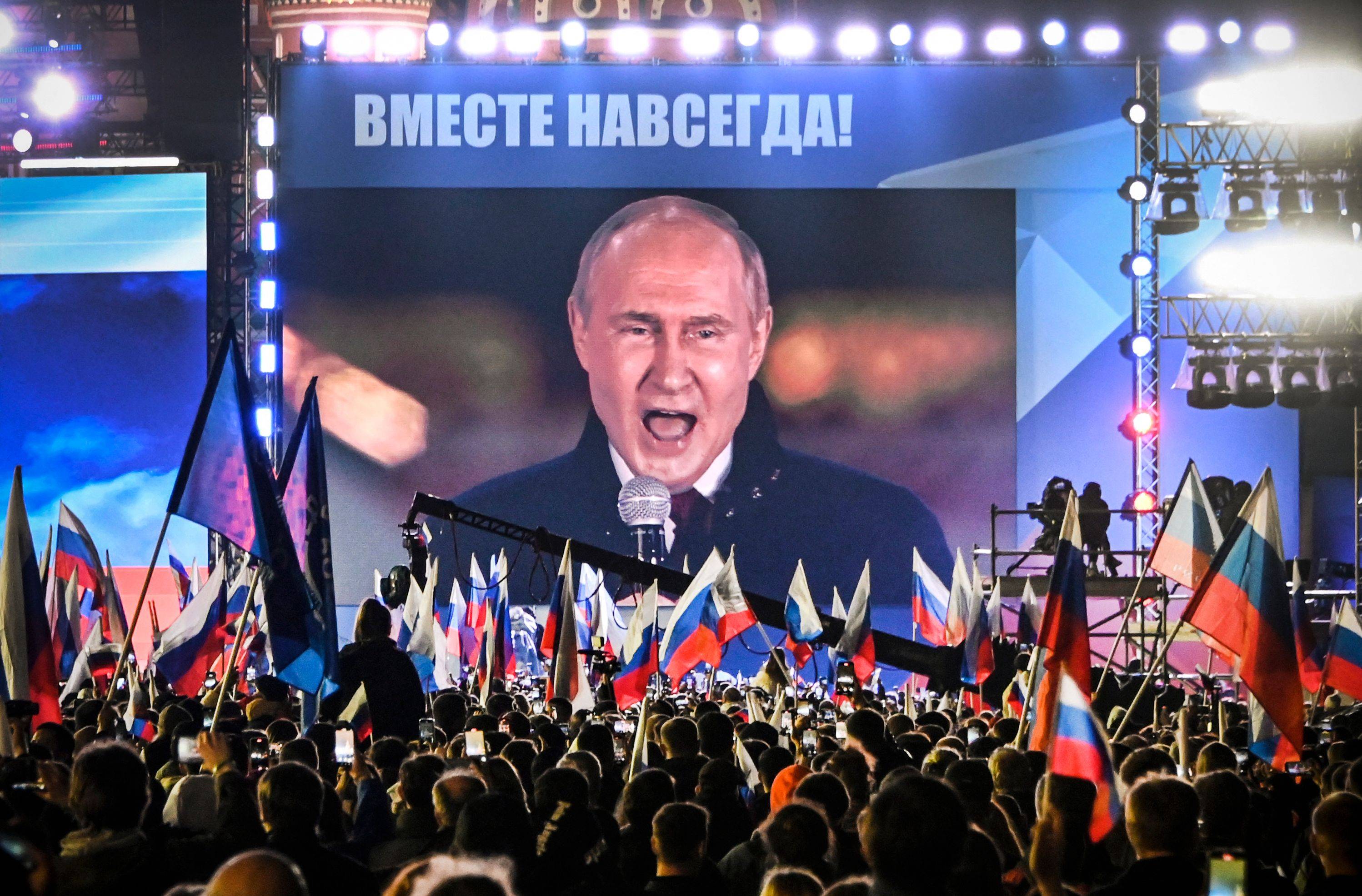 Russian President Vladimir Putin is seen on a screen in Moscow's Red Square as he addresses a rally and a concert marking the annexation of four Russian-occupied regions of Ukraine on Friday. | AFP-JIJI