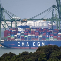 A ship docks in Singapore on Sept. 21. The world economy is showing signs of a rapid downshift as it contends with a series of shocks, increasing the likelihood of another global recession and the danger of major financial disruptions. | AFP-JIJI