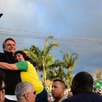 Bolsonaro waves at supporters during a motorcade in Joinville, Brazil, on Saturday.  | AFP-JIJI