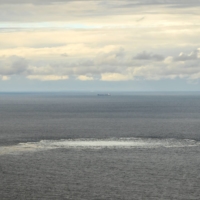 A Danish defense aircraft flies near one of the Nord Stream gas leaks in the Baltic Sea on Friday.   | DANISH DEFENSE COMMAND / VIA REUTERS  