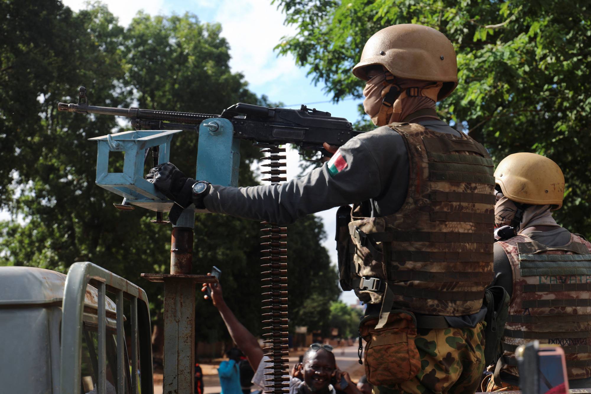 Burkina Faso junta's soldiers stand guard in an armored vehicle in the capital city, Ouagadougou, on Sunday.   | REUTERS