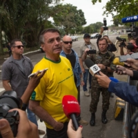 Brazilian President Jair Bolsonaro speaks to members of the media after casting his ballot at a polling station in Rio de Janeiro on Sunday. | BLOOMBERG