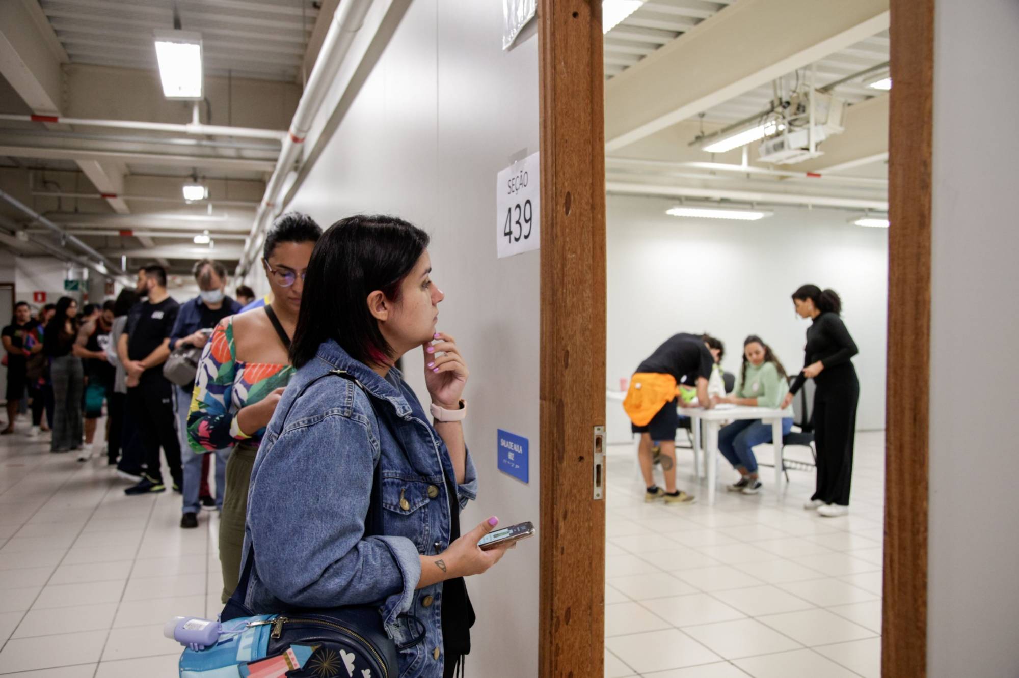 Voters wait in line to cast ballots in Sao Paulo on Sunday. | Bloomberg 