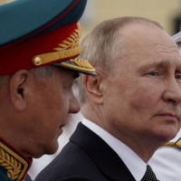 Russian President Vladimir Putin and Defense Minister Sergei Shoigu attend a parade marking Navy Day in St. Petersburg, Russia on July 31. | SPUTNIK / POOL VIA REUTERS 