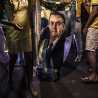 Supporters of President Jair Bolsonaro watch the exit polls in Brasilia on Sunday. | DADO GALDIERI / THE NEW YORK TIMES