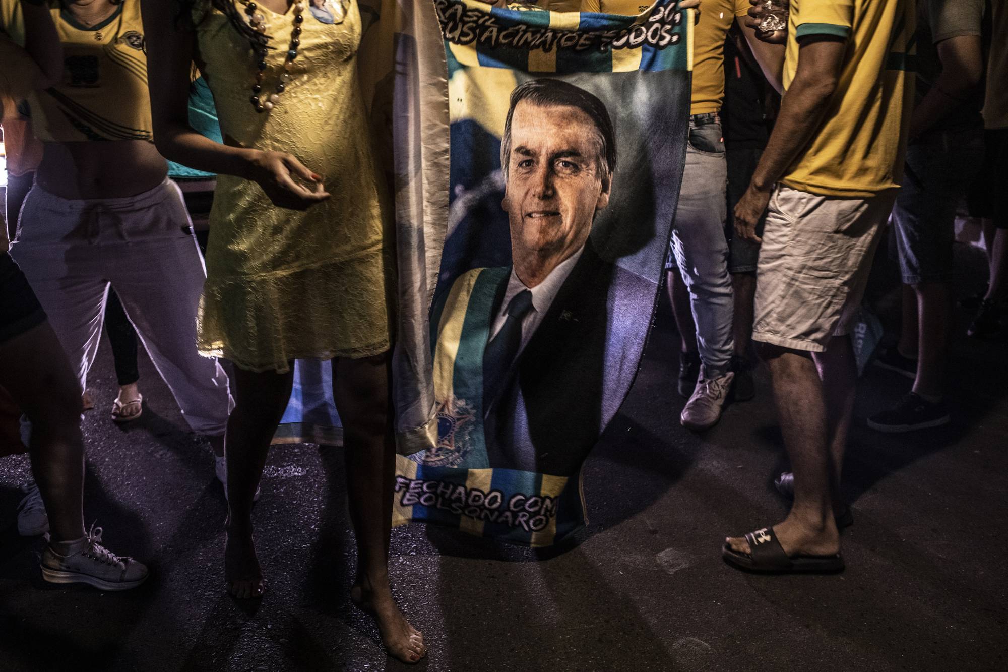 Supporters of President Jair Bolsonaro watch the exit polls in Brasilia on Sunday. | Dado Galdieri / The New York Times