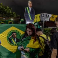Supporters gather in front of Bolsonaro\'s residence as votes are counted, in Rio de Janeiro on Sunday.  | MARIA MAGDALENA ARRELLAGA / THE NEW YORK TIMES