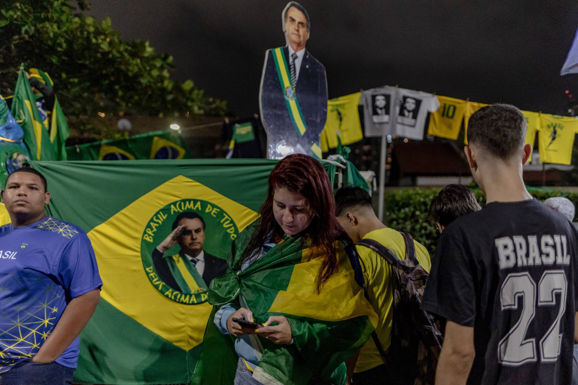 Supporters gather in front of Bolsonaro's residence as votes are counted, in Rio de Janeiro on Sunday. | Maria Magdalena Arrellaga / The New York Times