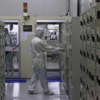 A member of staff approaches a locker at a lab at the Taiwan Semiconductor Research Institute at Hsinchu Science Park in Hsinchu, Taiwan, on Sept. 16.   | REUTERS