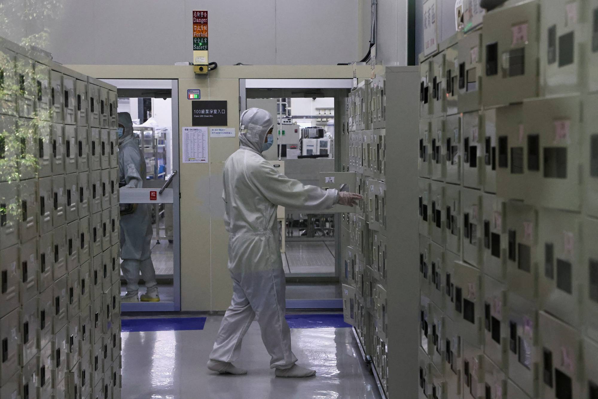 A member of staff approaches a locker at a lab at the Taiwan Semiconductor Research Institute at Hsinchu Science Park in Hsinchu, Taiwan, on Sept. 16. | REUTERS