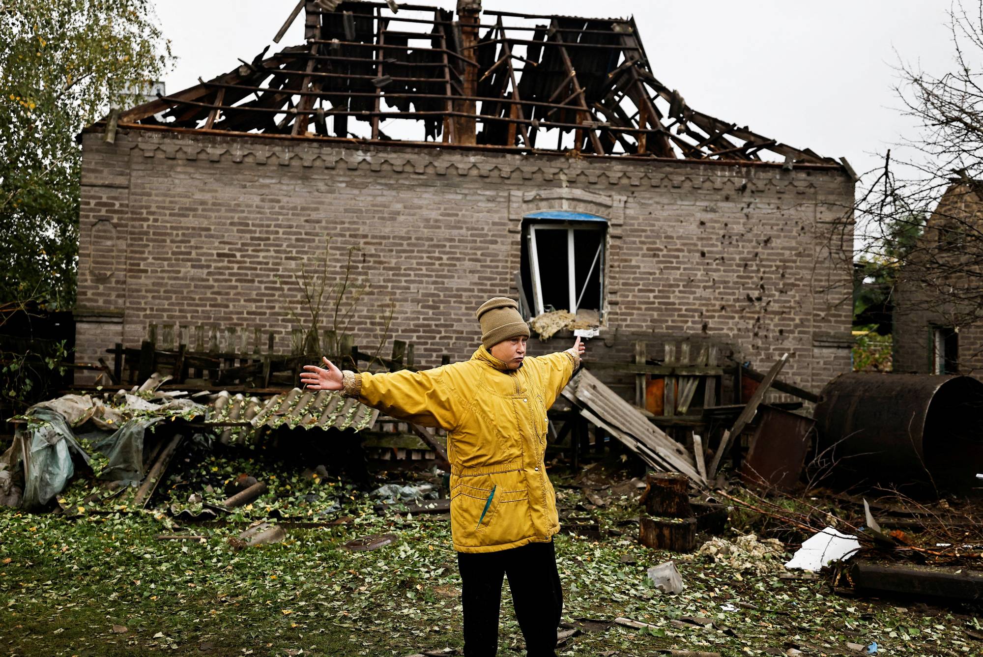 A woman speaks to journalists following a Russian missile strike in Kramatorsk, in Ukraine's Donetsk region, on Tuesday.  | Reuters 