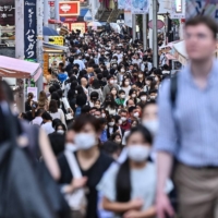 People walk down Takeshita Street in the popular Harajuku area of Tokyo on Sept. 23. Japan announced on September 22 that it would lift tough COVID-19 restrictions on foreign tourists, reopening the borders after two and a half years. | AFP-JIJI