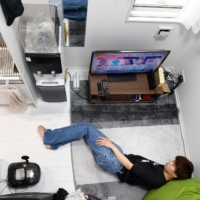 Yugo Kinoshita, 19, a college student with a part-time job, watches TV at home. | NORIKO HAYASHI / THE NEW YORK TIMES
