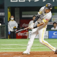 SoftBank\'s Yuki Yanagita hits a third-inning grand slam against Seibu in Fukuoka on Sunday. | KYODO