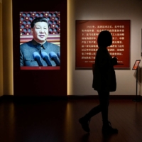 An image of Chinese President Xi Jinping is displayed at an exhibition in Beijing about the history of China\'s Communist Party. | AFP-JIJI