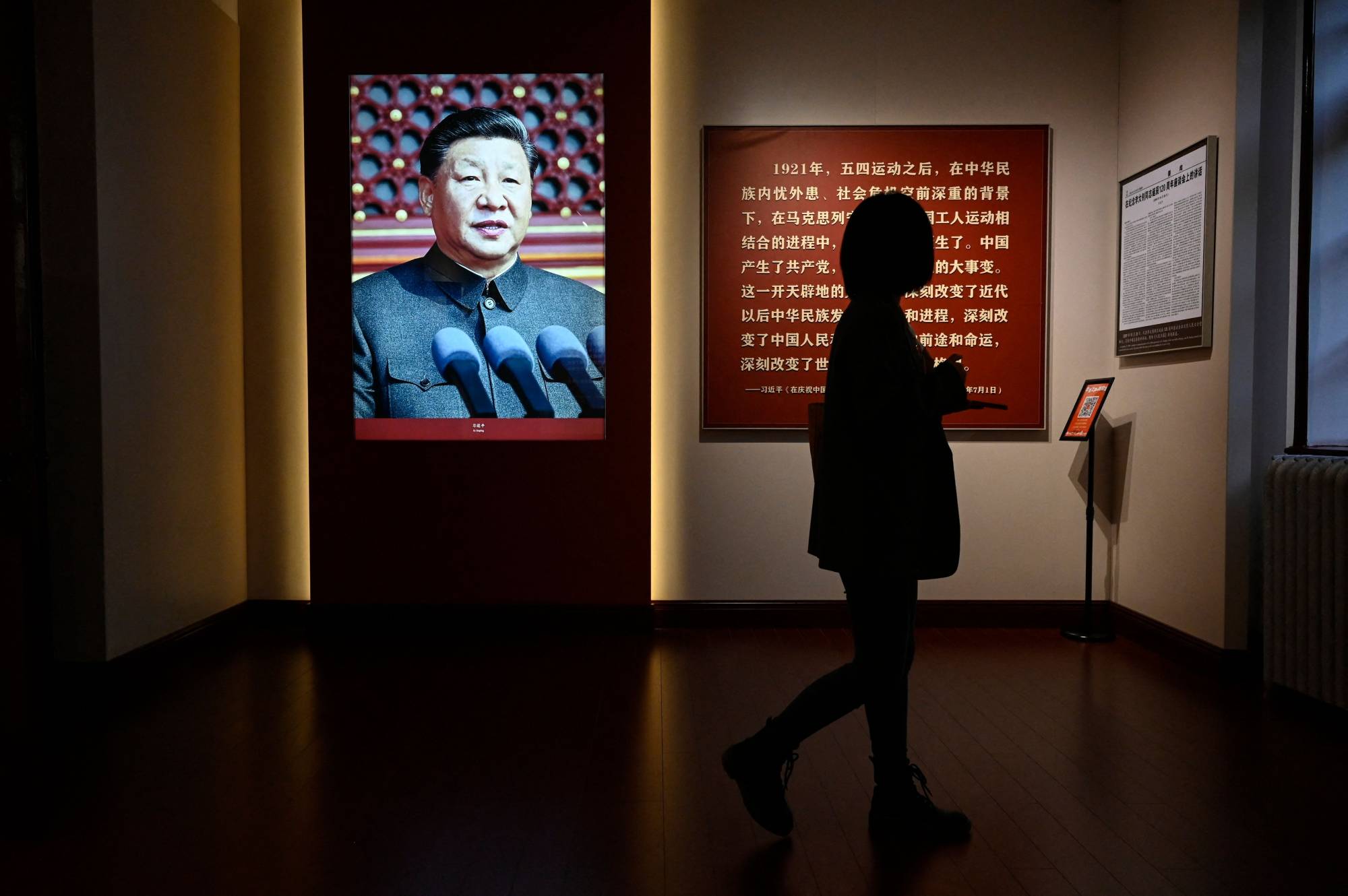 An image of Chinese President Xi Jinping is displayed at an exhibition in Beijing about the history of China's Communist Party. | AFP-JIJI