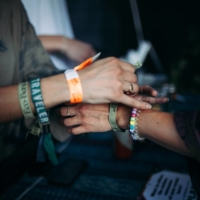 A group called Green Disco sells \'eco-bands\' that will offset carbon emissions at Deep Tropics at Bicentennial Capitol Mall State Park in Nashville, Tenn., on Aug. 27.  | TAYLOR BAUCOM / THE NEW YORK TIMES