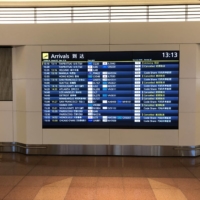 Haneda Airport in Tokyo on Tuesday. While the prospect of incoming visitors from overseas will be welcomed with open arms by the struggling tourism industry, many fear that an economic recovery driven by an influx of foreign money may be a long time in coming. | WILL FEE

