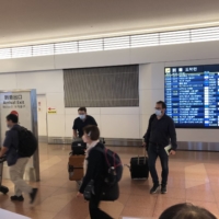 Arrivals for purposes other than tourism have been allowed since March this year, and many of those arriving at Tokyo’s Haneda Airport on Tuesday were either business travelers or residents returning after trips abroad. | WILL FEE
