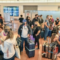 A group of tourists arrive at the international terminal of Tokyo\'s Haneda Airport on Tuesday, when Japan reopened to foreign independent travelers after two-and-a-half years of COVID-19 restrictions. | AFP-JIJI