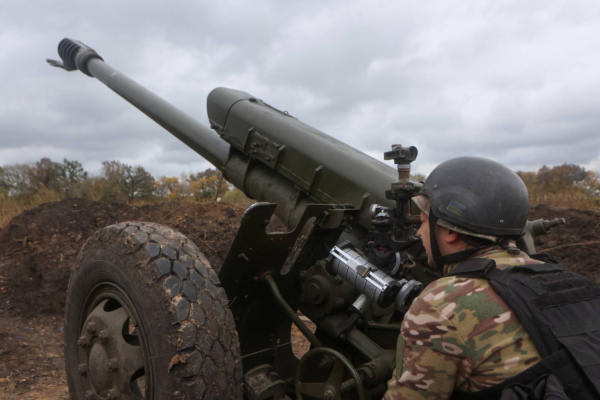 A member of the Ukrainian National Guard prepares a D-30 howitzer for fire toward Russian troops in the Kharkiv region on Oct. 5. | REUTERS
