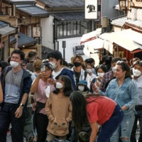 Tourists in Kyoto on Tuesday. The domestic travel discount program is causing confusion among travelers and tourist agencies. | KYODO