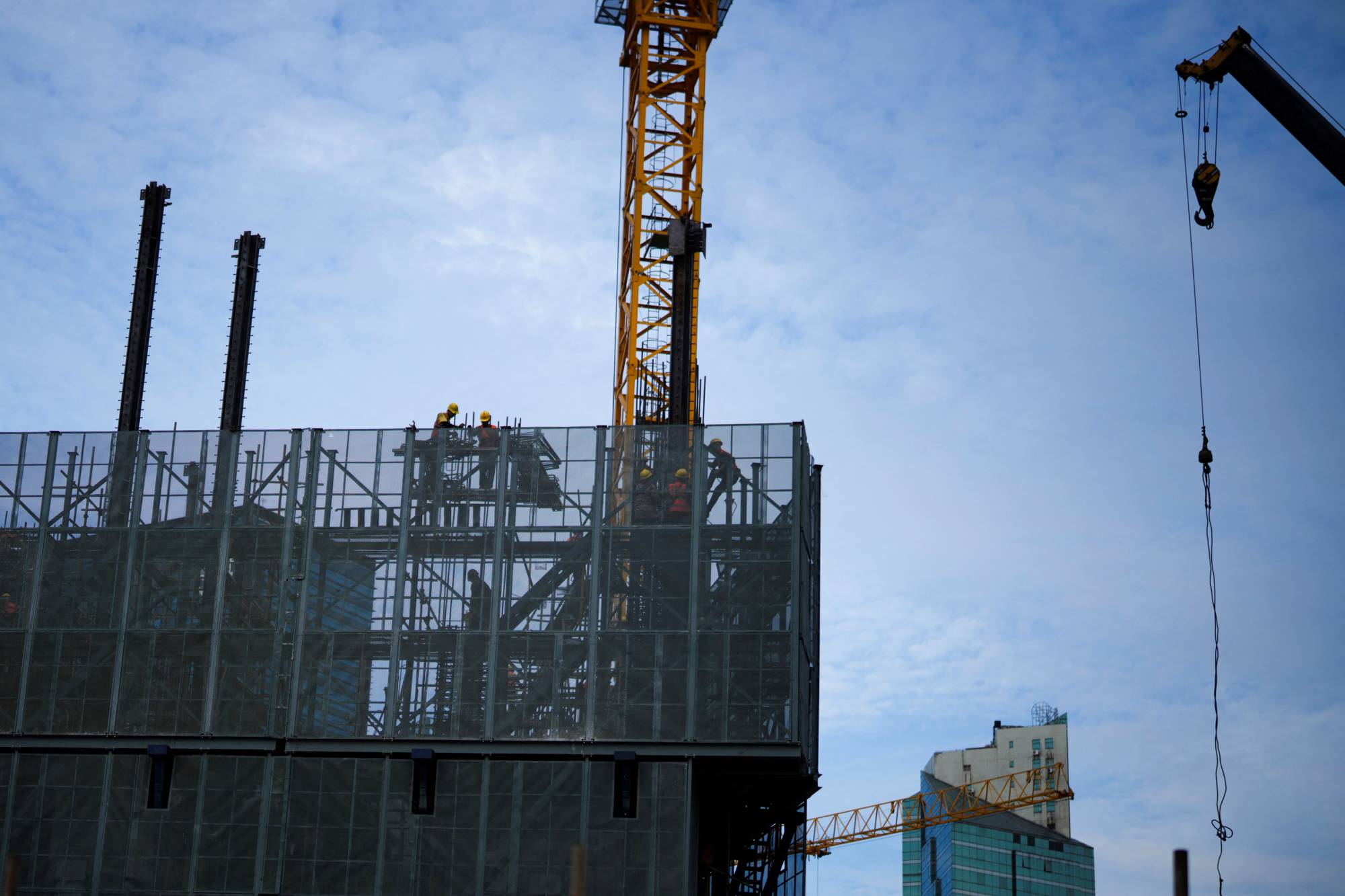 Workers at a construction site in Shanghai in September. | REUTERS