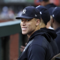 New York Yankees center fielder Aaron Judge smiles in the dugout during a game against the Texas Rangers at Globe Life Field, in Arlingotn, Texas, on Oct. 5.  | USA TODAY / VIA REUTERS