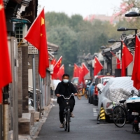 An alley in Beijing lined with Chinese flags ahead of the party congress | REUTERS