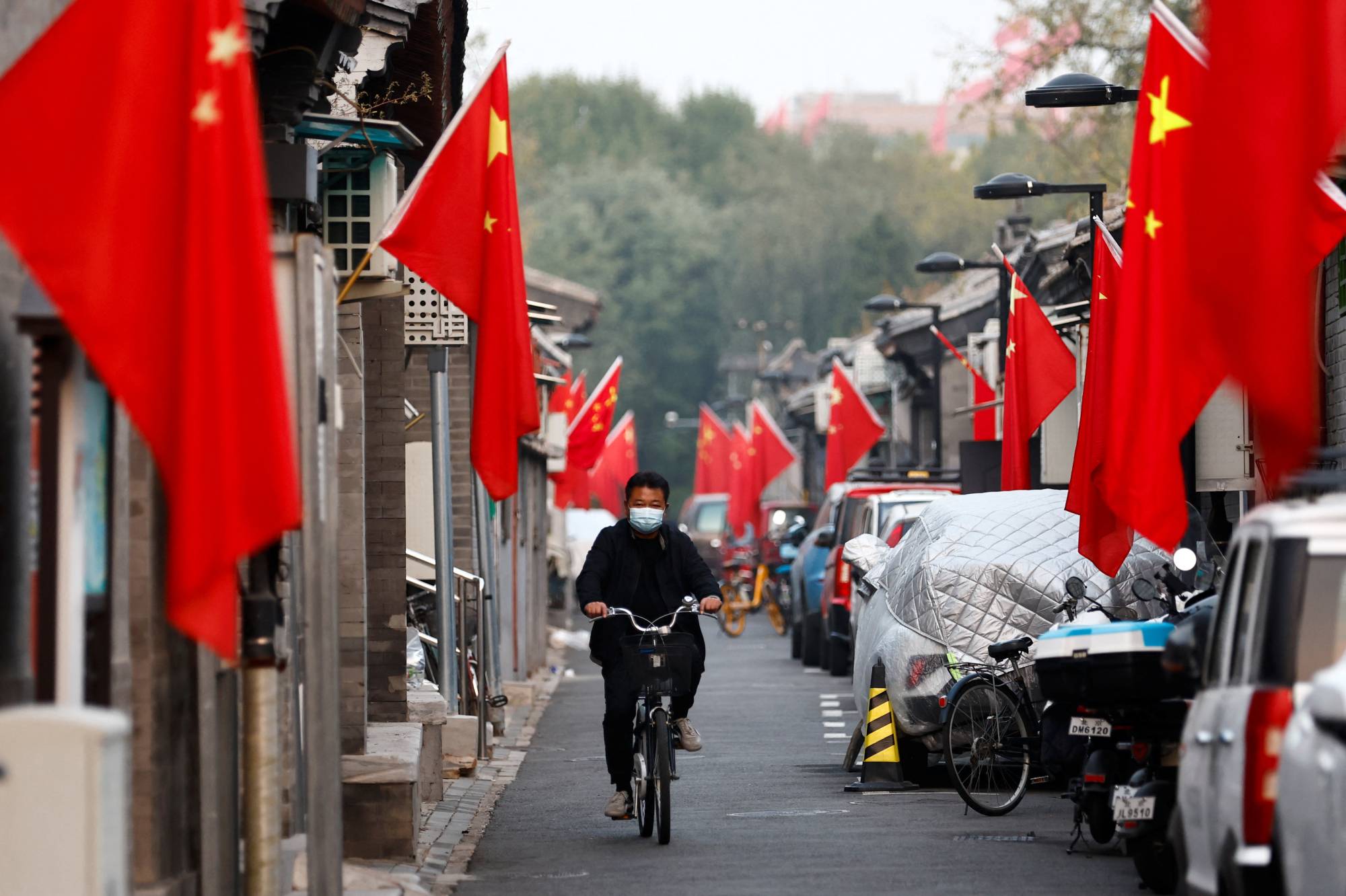 An alley in Beijing lined with Chinese flags ahead of the party congress | Reuters