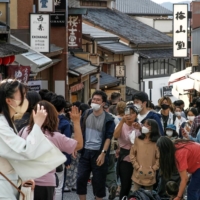 A street in Kyoto is crowded with tourists on Tuesday, when Japan significantly eased COVID-19 border controls and started the National Travel Discount program. | KYODO