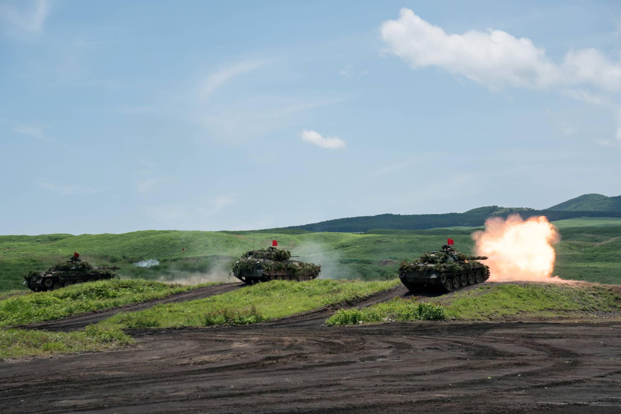 A Ground Self-Defense Force battle tank fires ammunition during a live-fire exercise at East Fuji Maneuver Area in Gotemba, Shizuoka Prefecture, in May. | POOL / VIA REUTERS