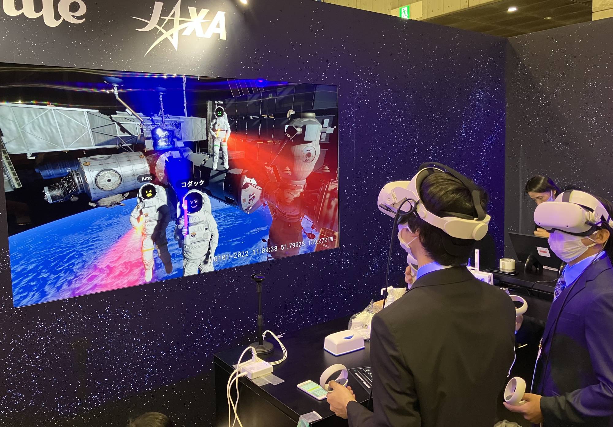 Visitors put on headsets to virtually experience being astronauts and space-walking around the International Space Station during the CEATEC 2022 exhibition in Chiba on Tuesday. | KAZUAKI NAGATA