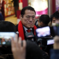 Former pro-wrestler turned Japanese lawmaker Antonio Inoki speaks to reporters before heading to North Korea at Beijing Capital International Airport in January 2014. Inoki visited North Korea a number of times to promote sports exchanges and meet with senior officials. | REUTERS
