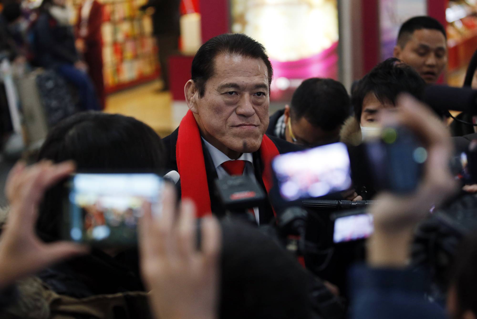 Former pro-wrestler turned Japanese lawmaker Antonio Inoki speaks to reporters before heading to North Korea at Beijing Capital International Airport in January 2014. Inoki visited North Korea a number of times to promote sports exchanges and meet with senior officials. | REUTERS