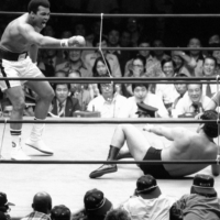 Antonio Inoki (right) takes on world boxing champion Muhammad Ali at the Nippon Budokan hall in Tokyo in June 1976. | KYODO
