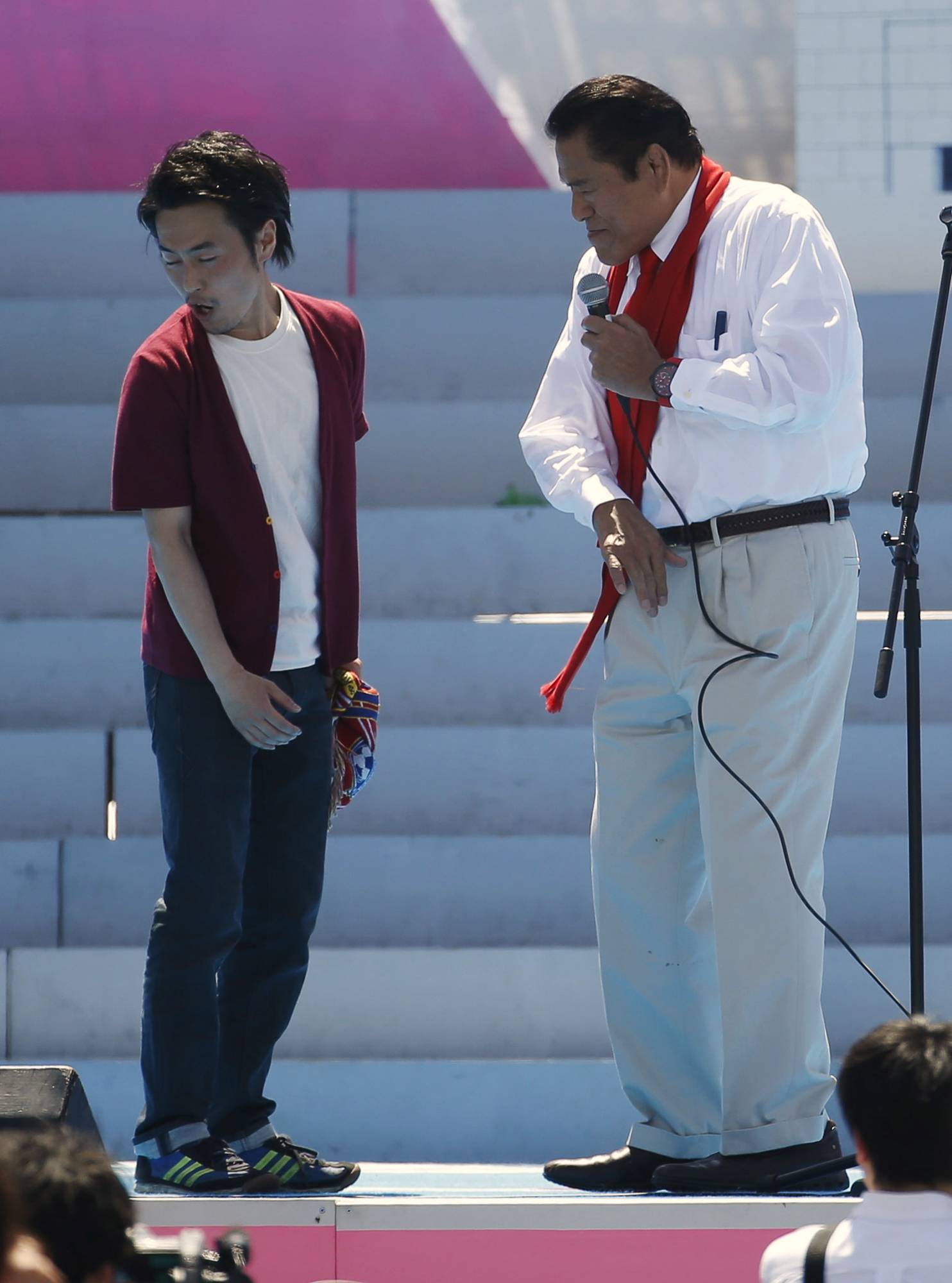 Inoki slaps a man's face as a part of his performance during a celebration ceremony to mark the 60th anniversary of the establishment of the pro-Pyongyang General Association of Korean Residents in Japan (Chongryon), in Tokyo in May 2015. | Reuters