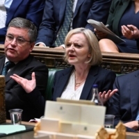 British Prime Minister Liz Truss (center) reacting during Prime Minister\'s Questions in the House of Commons in London on Wednesday. Truss is addressing lawmakers in parliament for the first time since abandoning her disastrous tax-slashing economic policies as she fights for her political life. | U.K. PARLIAMENT / VIA AFP-JIJI