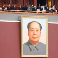 Chinese President Xi Jinping waves above a giant portrait of late Chinese chairman Mao Zedong at the end of the event marking the 100th founding anniversary of the Communist Party of China, on Tiananmen Square in Beijing in July 2021 | REUTERS